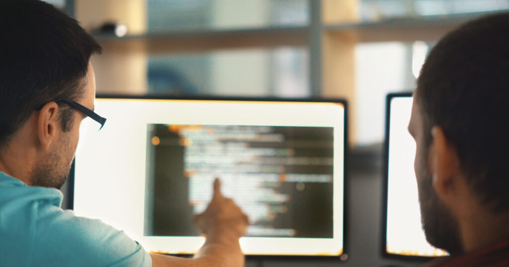 picture of two people looking at a computer